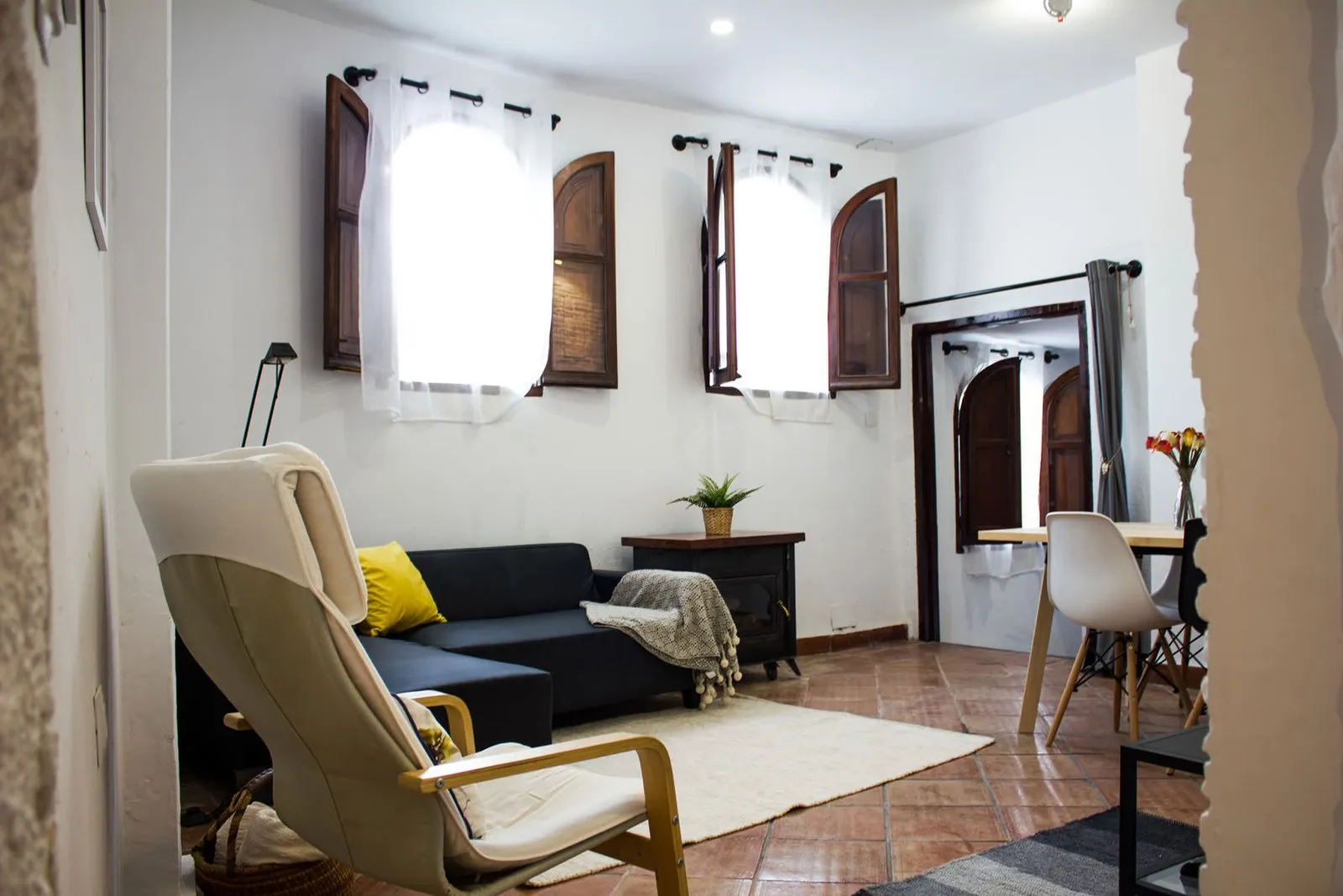 Reading corner in the living room by windows with wooden shutters