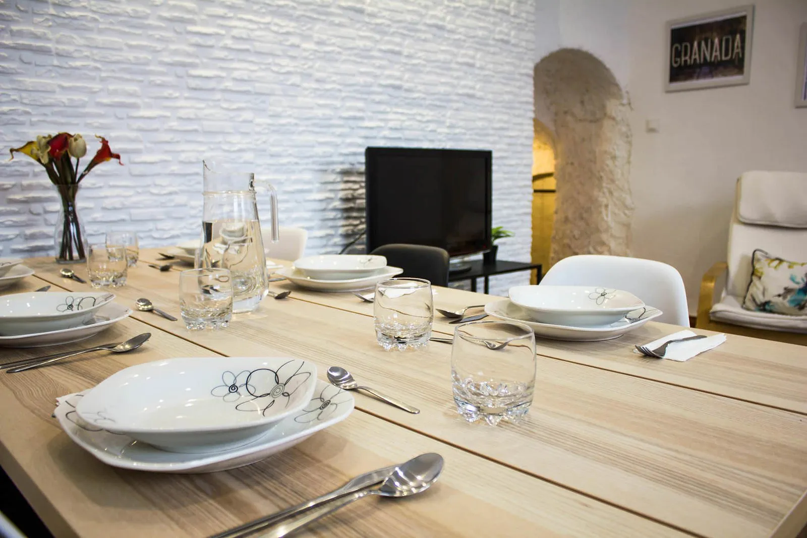 Close-up of the laid table with plates, glasses and flowers